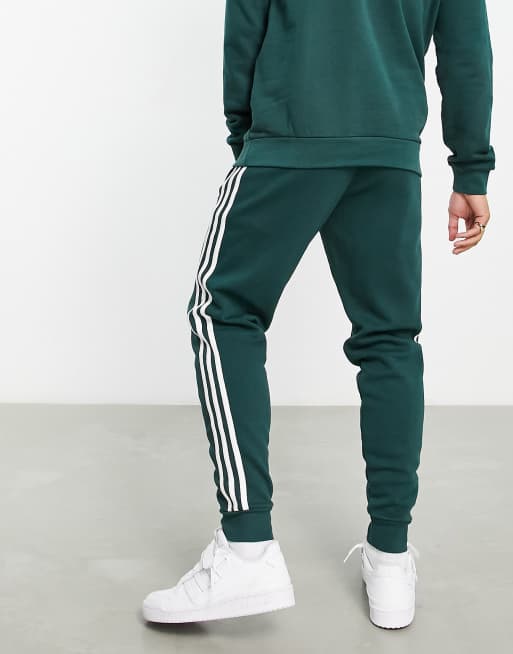 adidas Originals Tall adicolor three stripe joggers in green