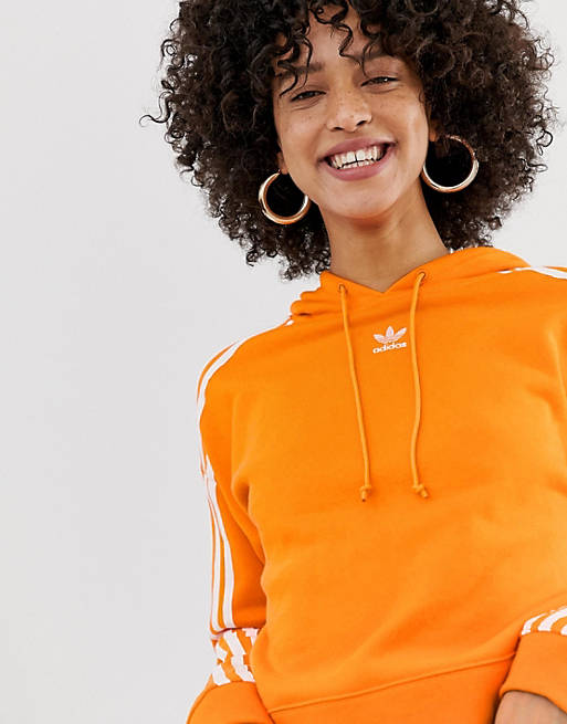 neumático Rezumar altura adidas Originals three stripe hoodie in orange | ASOS