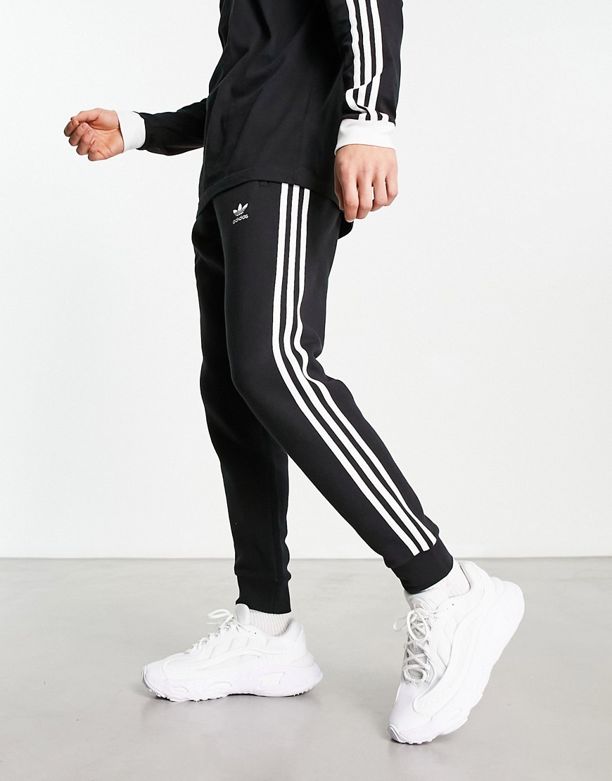 adidas Originals three stripe joggers in black
