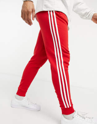 black adidas joggers red stripes