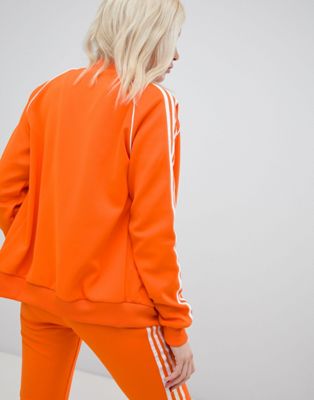 adidas originals three stripe cigarette pants in orange