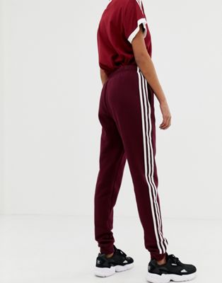 adidas originals three stripe track pants in burgundy