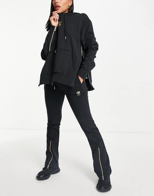 adidas Originals – Trainingshose in Schwarz mit goldfarbenem Logo und Saumschlitzen