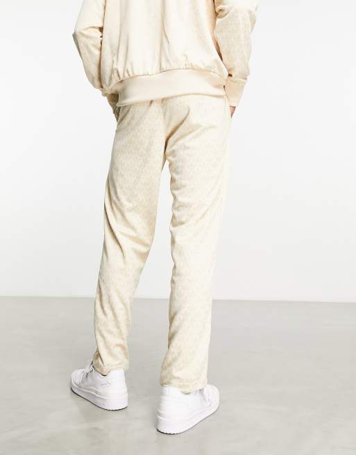 adidas Originals Trefoil monogram trackpants in neutral