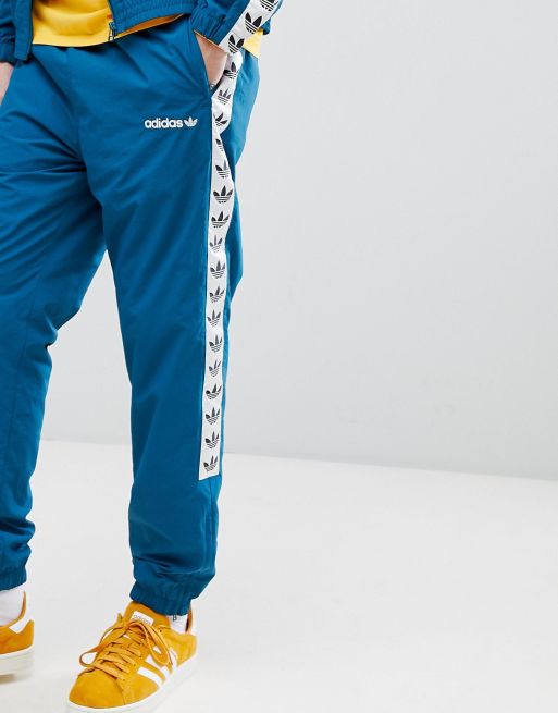 Adidas originals vintage track pants with taped side stripe in blue cheap