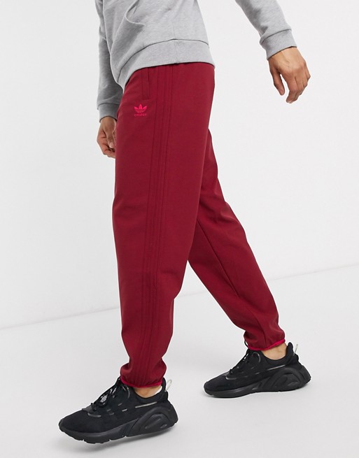 adidas Originals winterized joggers with three stripe in burgundy tech pack