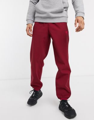 adidas originals three stripe track pants in burgundy