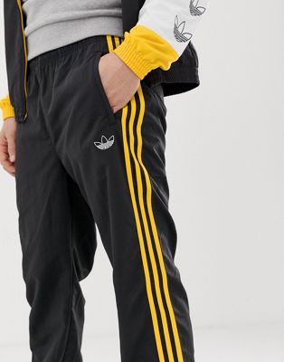 adidas pants with yellow stripes
