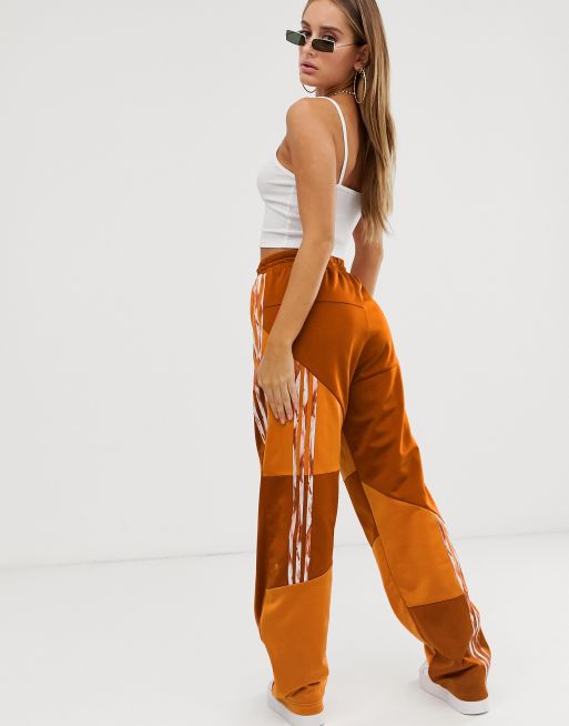 adidas Originals x Danielle Cathari deconstructed Firebird track pant in orange