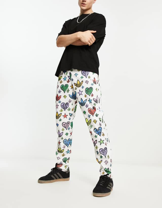 adidas Originals x Jeremy Scott Firebird track pants in all over print in multi