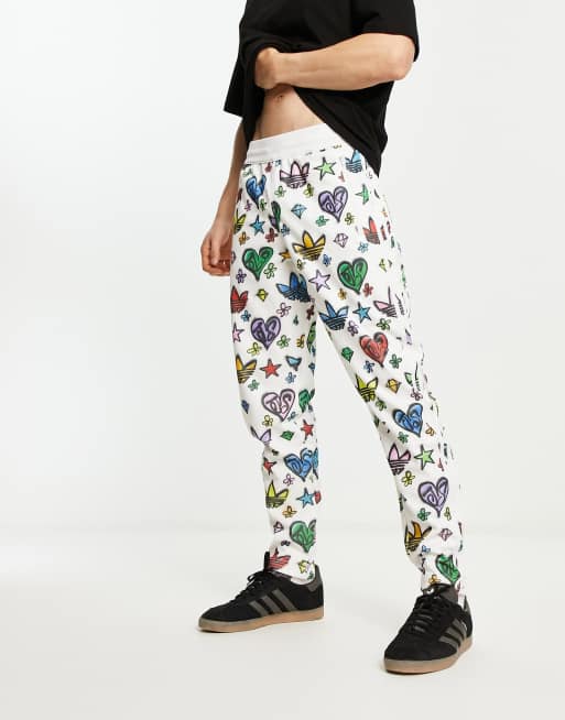 adidas Originals x Jeremy Scott Firebird track pants all over print multi | ASOS