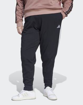 adidas Performance - Essentials - Plus-Size-Jogginghose aus Fleece in Schwarz/Weiß mit den drei Streifen