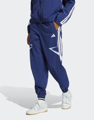 adidas Performance - Tiro Cut - Hose in Dunkelblau / Glow Blue mit Color-Block-Design, den 3 Streifen und Bündchen