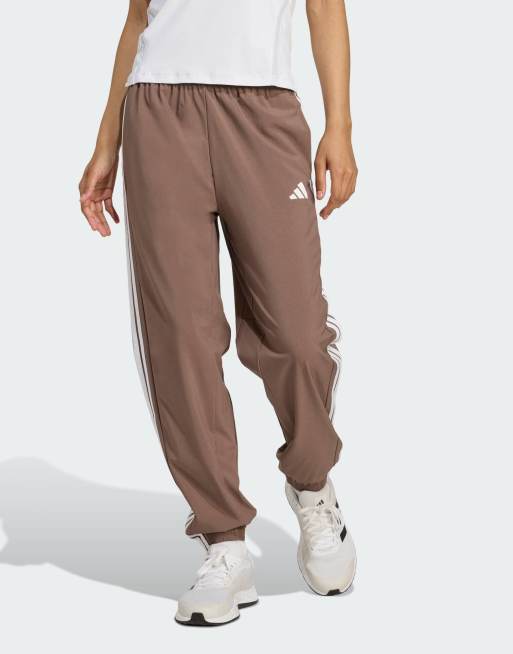 adidas performance Train essentials 3-stripes woven pants in brown / white