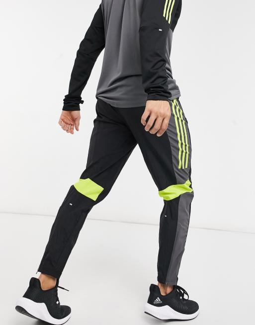 adidas Running Pantaloni sportivi neri e gialli