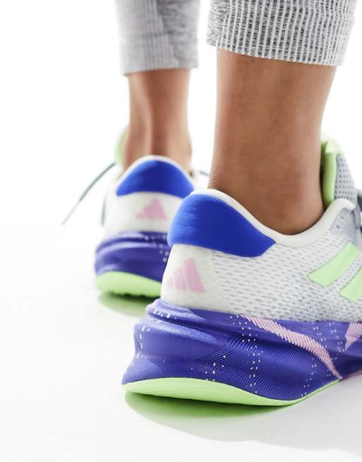 adidas Running Supernova Stride trainers in white blue and neon green