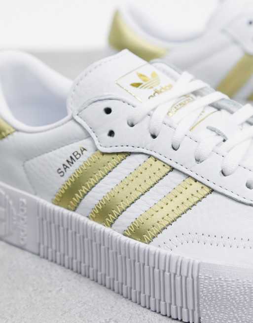 White adidas best sale with gold stripes