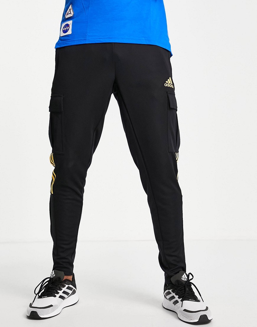 Adidas Soccer Tiro pants with yellow three stripes in black