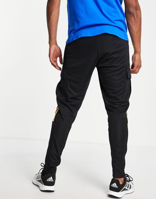 adidas Soccer Tiro pants with yellow three stripes in black