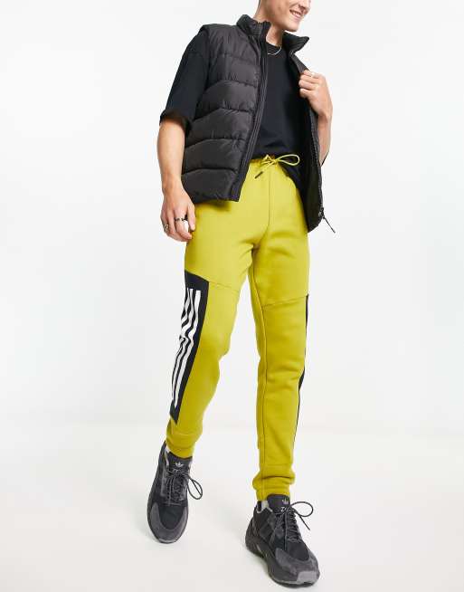 adidas Sportstyle Future Icons 3 stripe sweatpants in green  