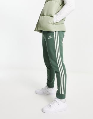 adidas Sportswear Essential 3 stripe trackies in green  - ASOS Price Checker