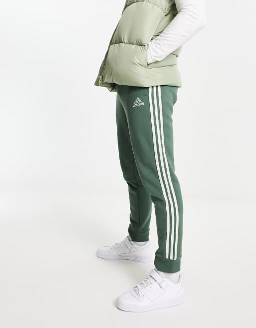 adidas Sportswear Essential 3 stripe jogger in green