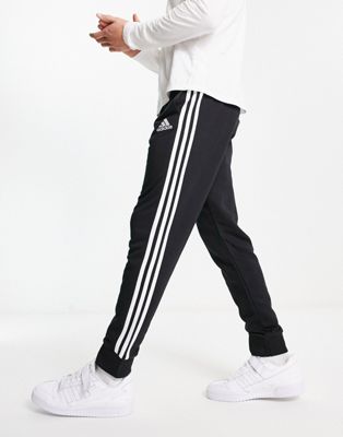 adidas Sportswear Essential 3 stripe trackies in black  - ASOS Price Checker