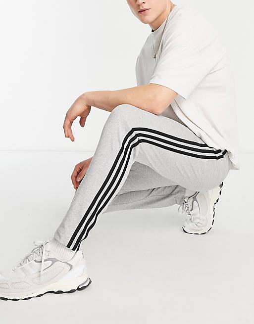 adidas Sportswear Essential 3 stripe trackies in grey