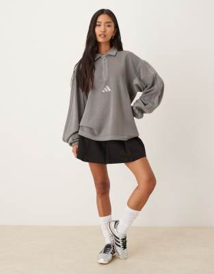 adidas Sportswear - Langärmliges Polohemd in gewaschenem Schwarz