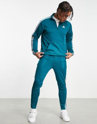 adidas – Sportswear – Trainingsanzug aus Trikot-Material in Blaugrün mit 3 Streifen