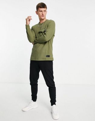 T-shirts et débardeurs adidas - Top à manches longues et poche fonctionnelle - Kaki