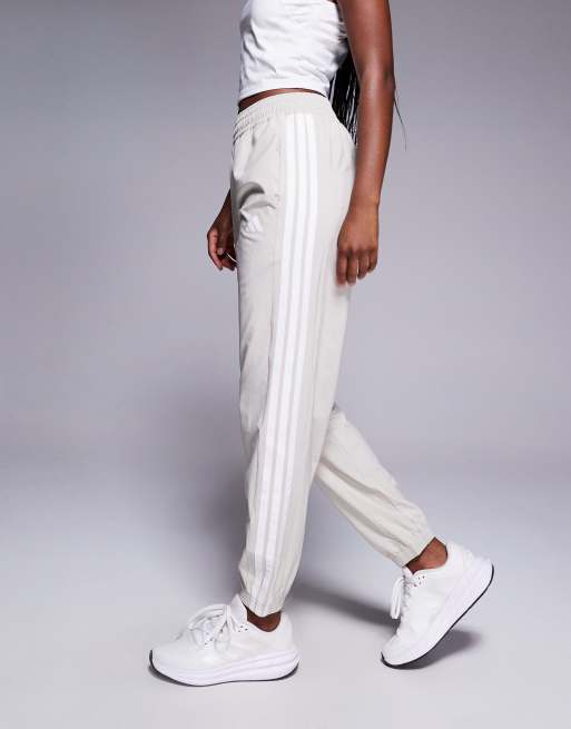 adidas Training 3 stripe woven joggers in stone