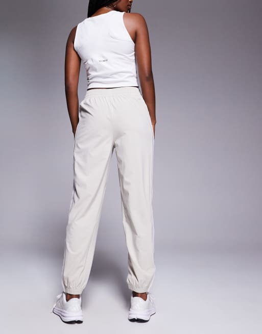 adidas Training 3 stripe woven joggers in stone