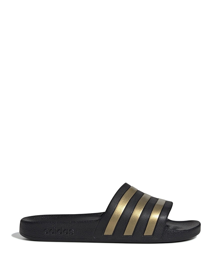 adidas Training Adilette sliders in black and gold