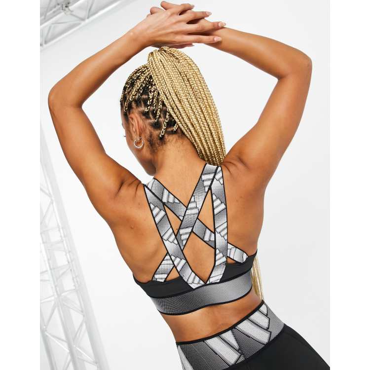 adidas Training mid-support sports bra with branded back straps in black |  ASOS