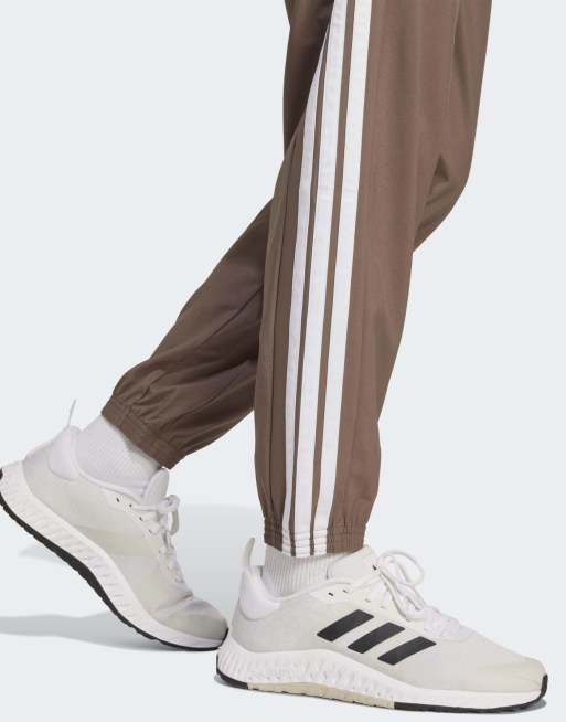 adidas Training Train essentials 3-stripes woven pants in brown / white
