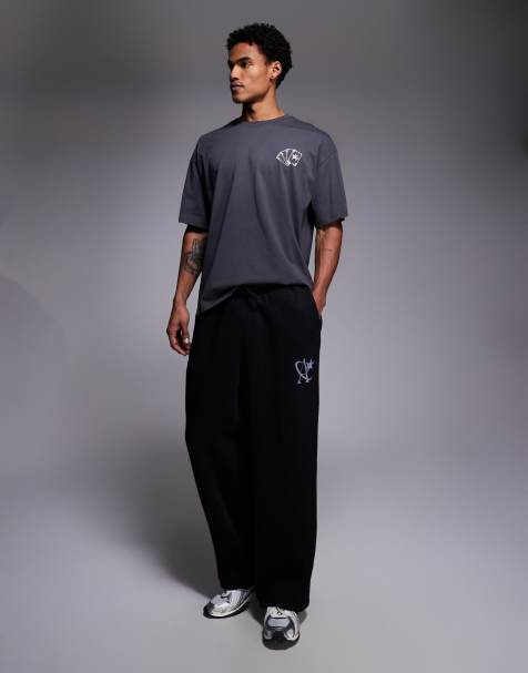 ADPT loose fit joggers with star logo in washed black