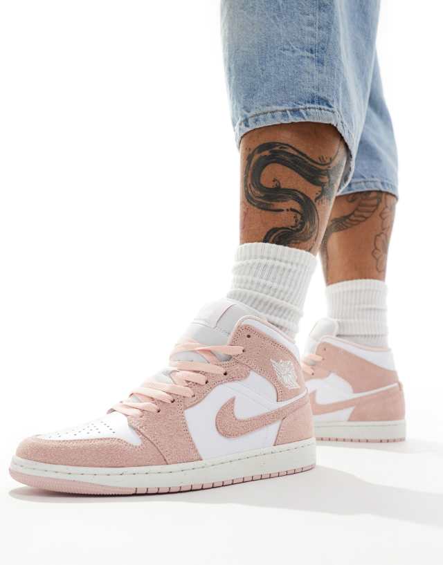 Jordan - air  1 mid se trainers in white and pink .