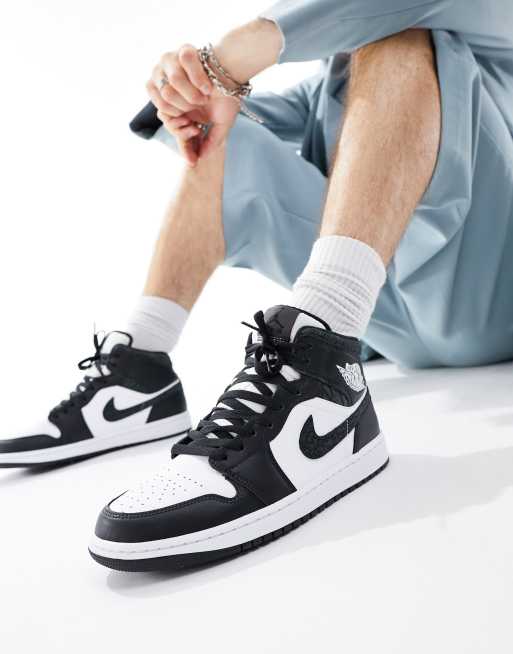 Air Jordan 1 Mid trainers in white and black