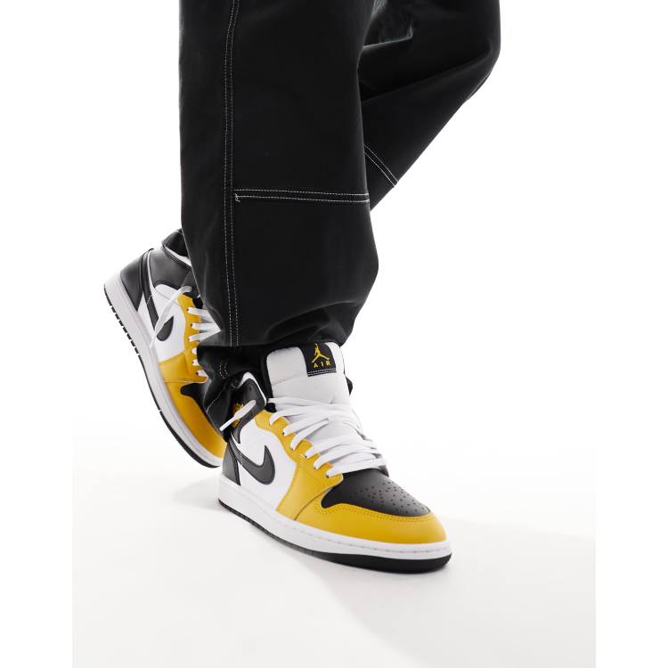 Air Jordan 1 Mid trainers in white and yellow