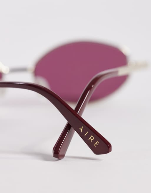 AIRE objective slim oval metal sunglasses in gold with burgundy lens, 2 of 3