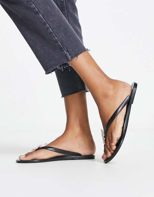 ALDO – Alelith – Svarta och guldfärgade flip flops med fjärilsdetalj , 2 av 4