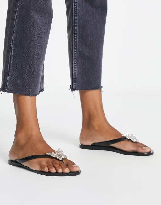 ALDO - Alelith - Teenslippers met vlinder in zwart en goud 