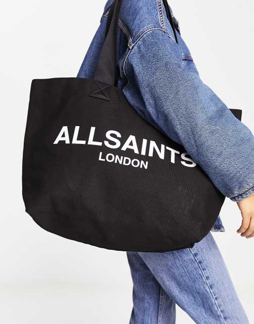 AllSaints – Ali – Tragetasche aus Canvas in Schwarz/Weiß
