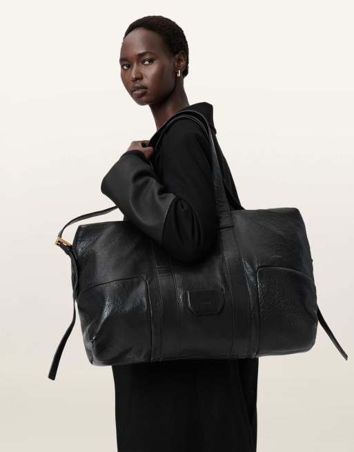 AllSaints – Ares – Genarbte Reisetasche in Schwarz