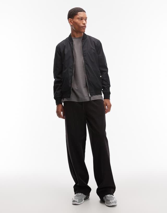 AllSaints Bassett reversible logo bomber jacket in black/green | ASOS