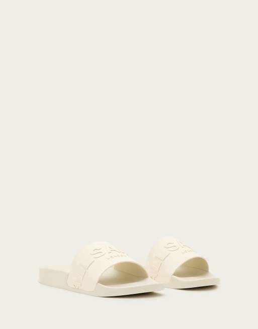 AllSaints - Biggy - Slippers van rubber met logo in dezelfde tint in gebroken wit