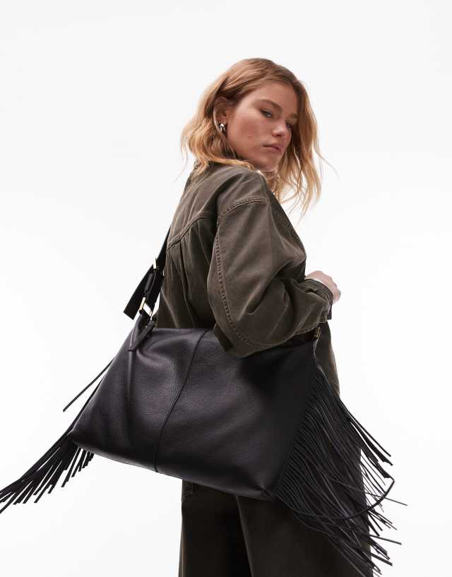 AllSaints Edbury suede fringe shoulder bag in black | ASOS