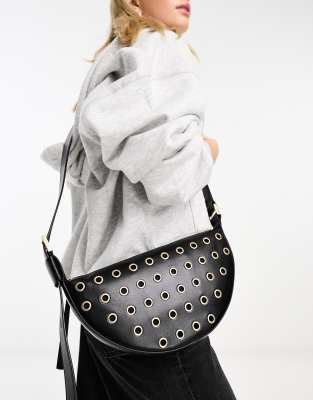 leather half moon eyelet crossbody bag in black