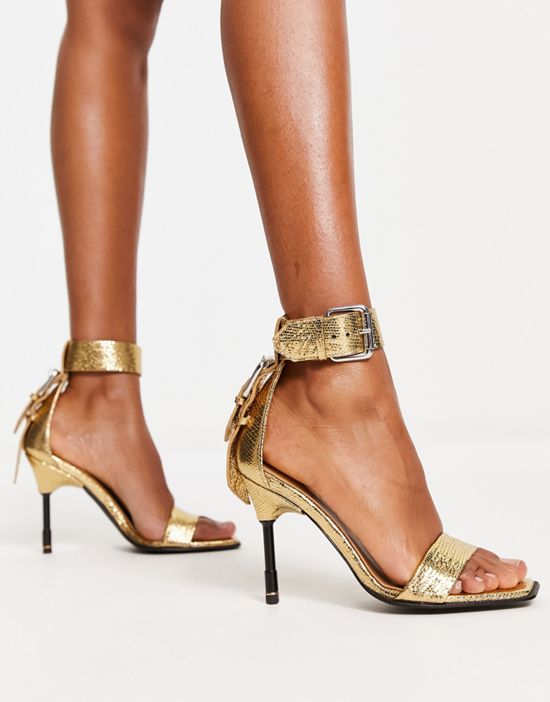 https://images.asos-media.com/products/allsaints-noir-metallic-leather-heeled-sandals-in-gold/203270778-4?$n_550w$&wid=550&fit=constrain